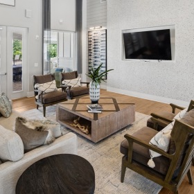 room with couch chairs and wall mounted tv