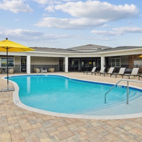 pool surrounded by lounge chairs and umbrellas